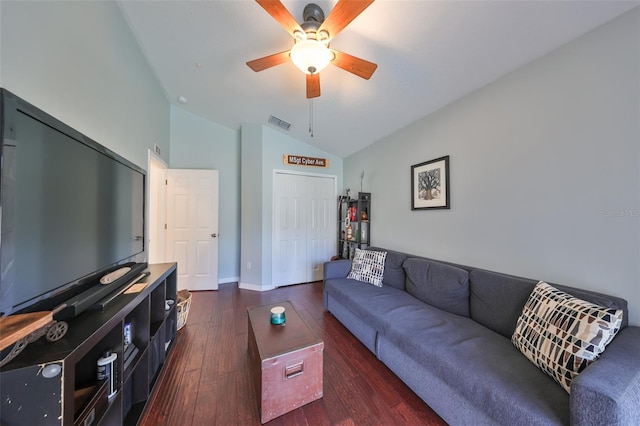 living room with ceiling fan, dark wood-type flooring, and vaulted ceiling