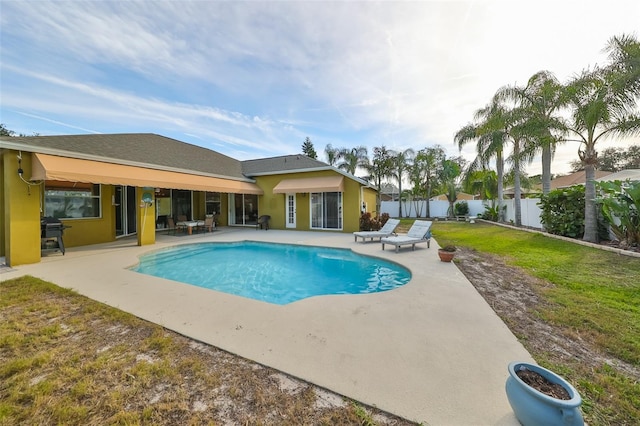 view of swimming pool with a yard, a patio, and area for grilling