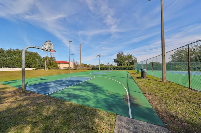 view of sport court featuring a yard