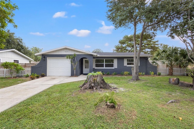 ranch-style home with a garage, a front yard, and fence