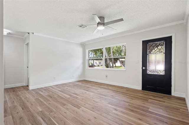 entrance foyer with ceiling fan, a textured ceiling, visible vents, light wood-style floors, and ornamental molding