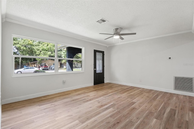 unfurnished room featuring ornamental molding, visible vents, and light wood finished floors