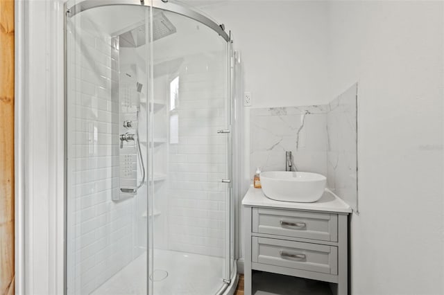 bathroom with a stall shower and vanity