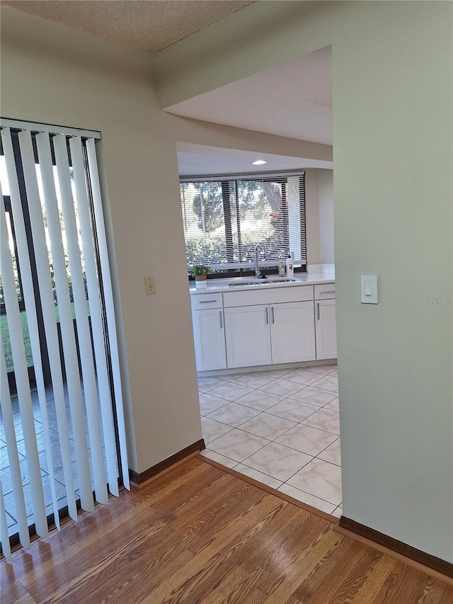 kitchen featuring sink, white cabinets, and light hardwood / wood-style floors