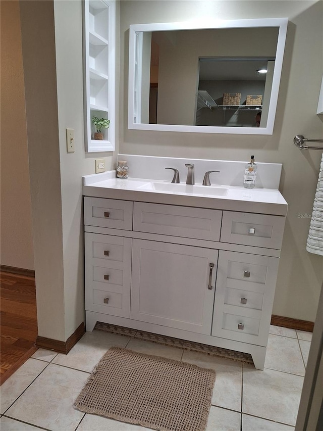 bathroom featuring tile patterned flooring and vanity