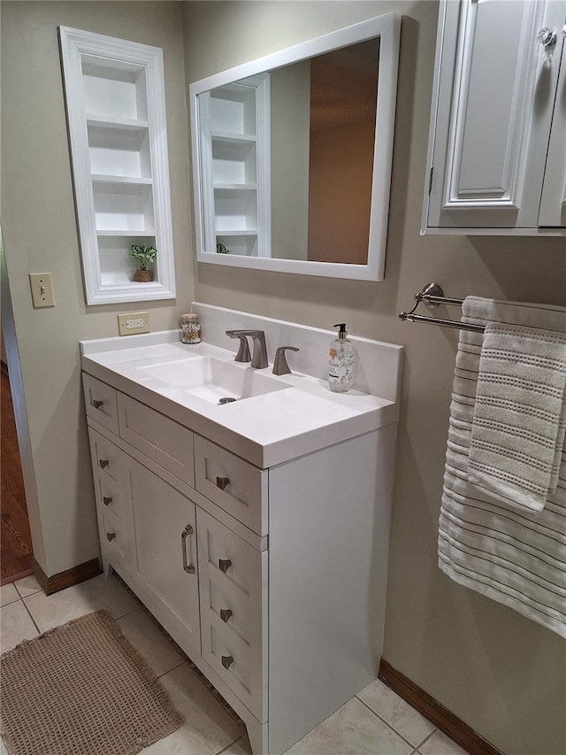 bathroom featuring tile patterned floors, built in shelves, and vanity