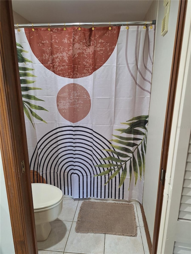 interior space with tile patterned flooring and toilet