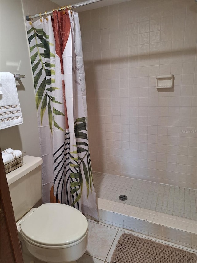 bathroom featuring tile patterned floors, toilet, and a shower with shower curtain