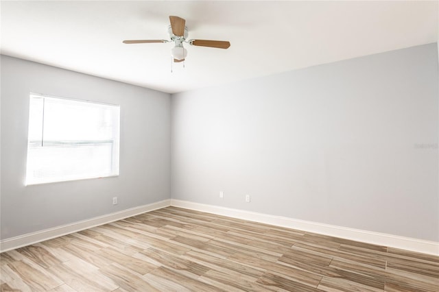 empty room with ceiling fan and light hardwood / wood-style floors