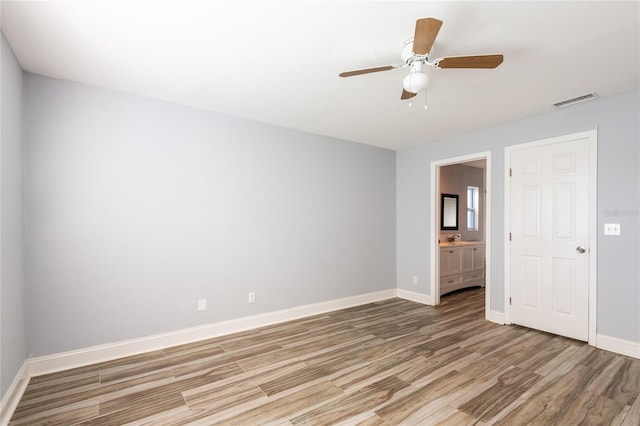 unfurnished room featuring hardwood / wood-style floors and ceiling fan