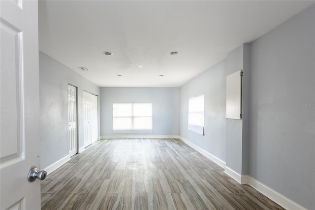 unfurnished room with hardwood / wood-style flooring