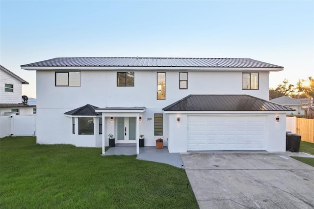 view of front facade featuring a garage and a yard