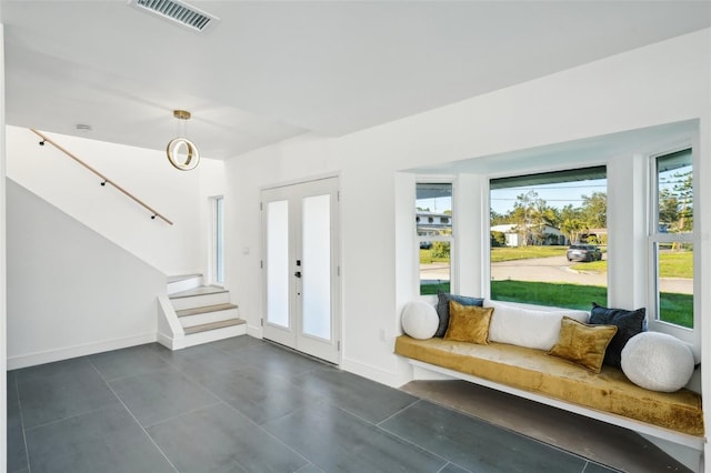 foyer entrance with french doors and a healthy amount of sunlight