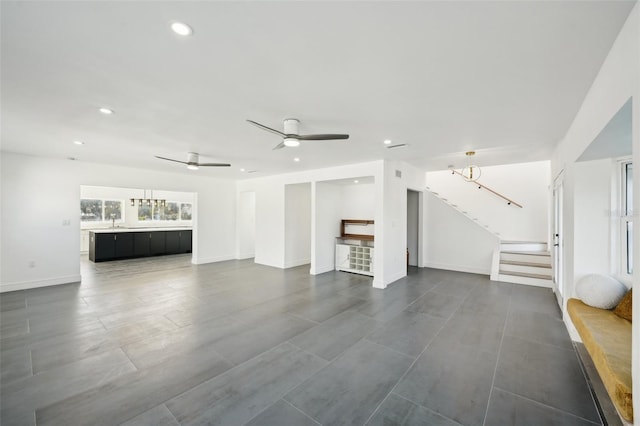 unfurnished living room featuring ceiling fan