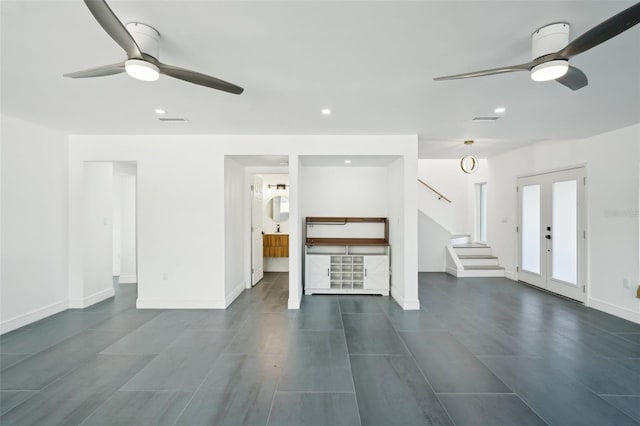 unfurnished living room with french doors and ceiling fan