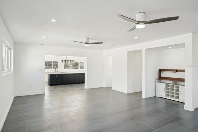 unfurnished living room with ceiling fan