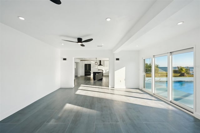 unfurnished living room featuring ceiling fan