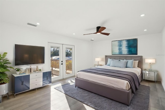 bedroom with wood-type flooring, access to outside, ceiling fan, and french doors