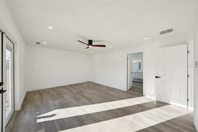 empty room featuring ceiling fan and light hardwood / wood-style flooring