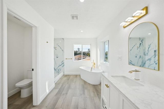 full bathroom with vanity, wood-type flooring, shower with separate bathtub, and toilet