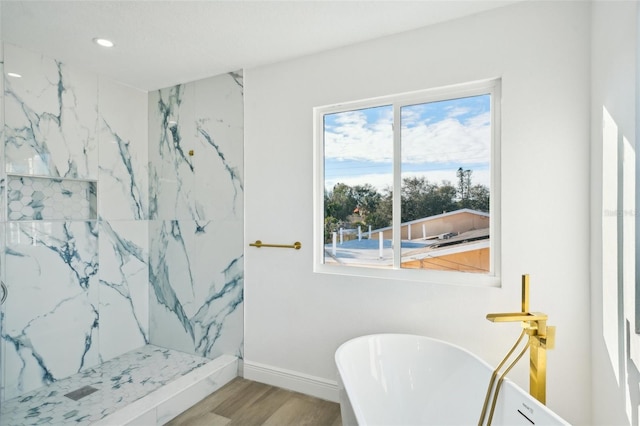 bathroom featuring hardwood / wood-style floors and independent shower and bath