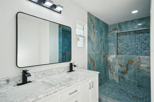 bathroom featuring vanity and a tile shower