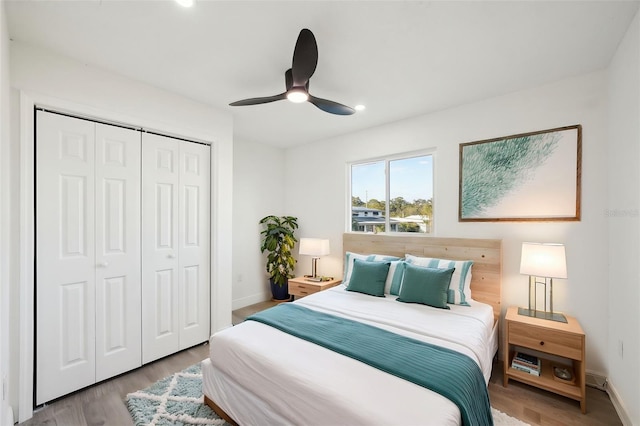 bedroom featuring ceiling fan, a closet, and light hardwood / wood-style flooring