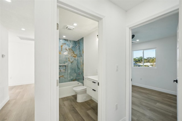 full bathroom featuring vanity, hardwood / wood-style flooring, and tiled shower / bath combo