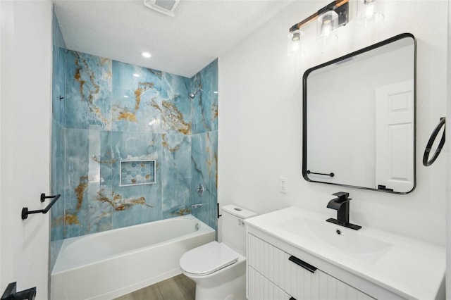 full bathroom with washtub / shower combination, hardwood / wood-style flooring, vanity, toilet, and a textured ceiling