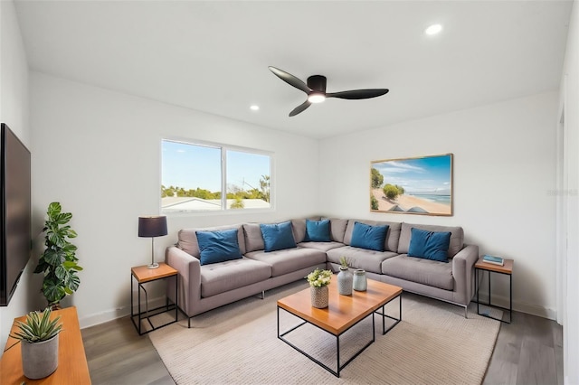 living room featuring hardwood / wood-style floors and ceiling fan