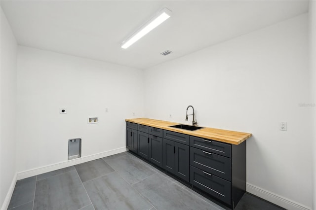 clothes washing area with washer hookup, sink, cabinets, and hookup for an electric dryer