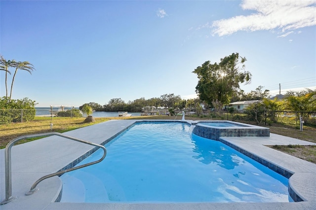 view of swimming pool featuring an in ground hot tub and a water view