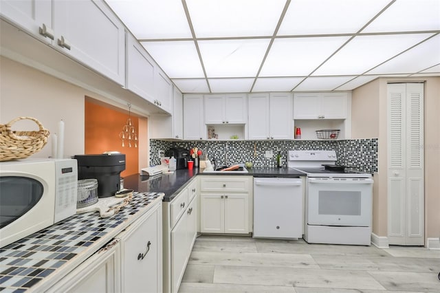 kitchen featuring tasteful backsplash, open shelves, white appliances, light wood-style flooring, and a paneled ceiling
