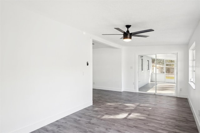 spare room featuring dark hardwood / wood-style floors and ceiling fan