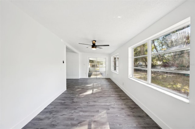 unfurnished sunroom with ceiling fan