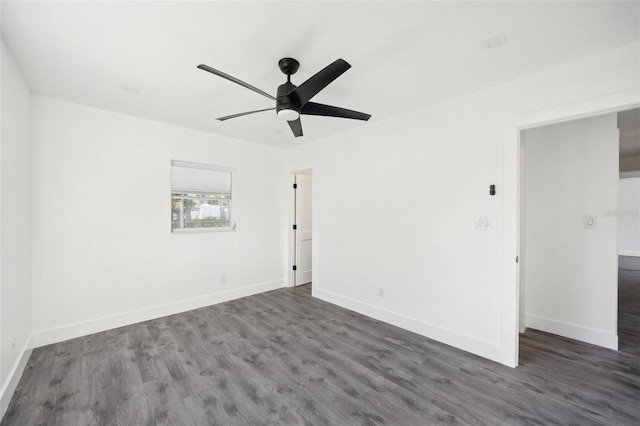 empty room with ceiling fan and dark wood-type flooring