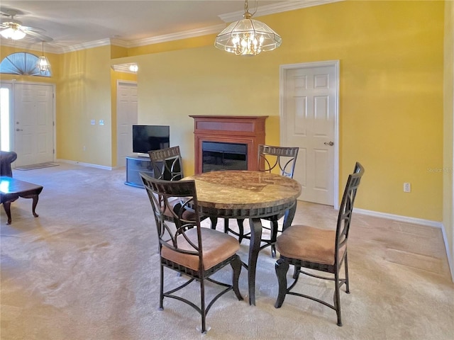 carpeted dining space featuring a notable chandelier and ornamental molding