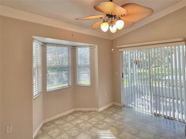 empty room featuring ornamental molding, vaulted ceiling, and ceiling fan