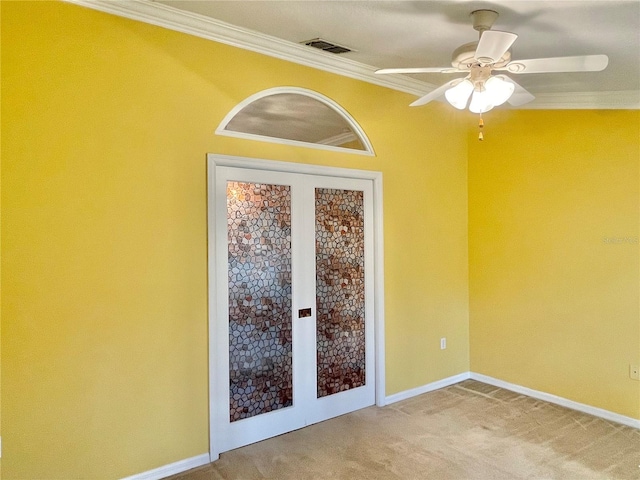 carpeted spare room featuring ceiling fan and crown molding