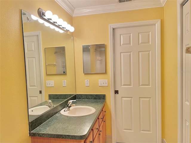 bathroom featuring crown molding and vanity