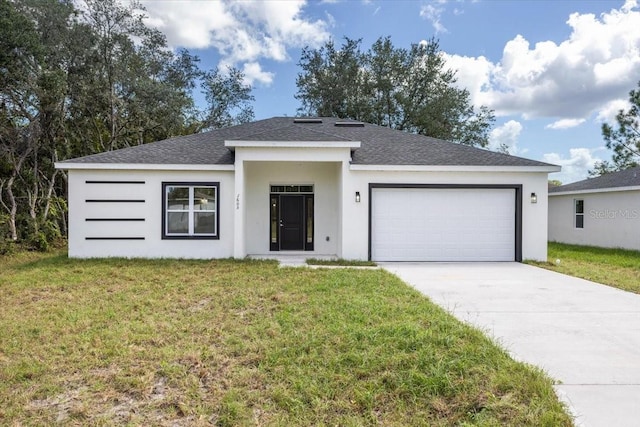 view of front facade with a front yard and a garage