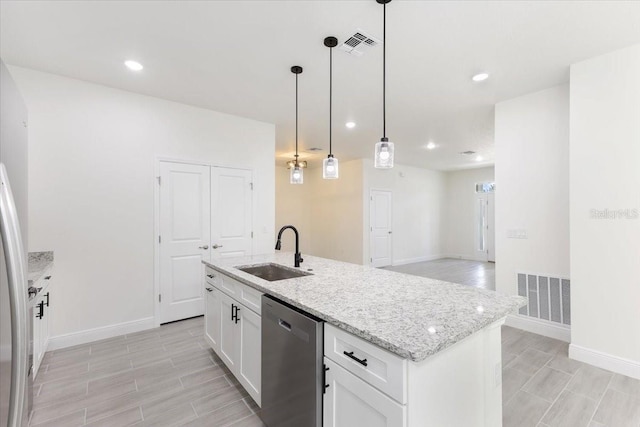 kitchen featuring sink, stainless steel dishwasher, decorative light fixtures, a center island with sink, and white cabinets