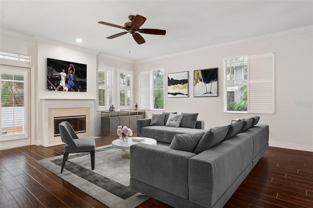 living room featuring ceiling fan, plenty of natural light, a premium fireplace, and dark wood-type flooring