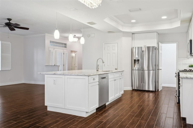 kitchen with light stone countertops, sink, white cabinetry, and stainless steel appliances