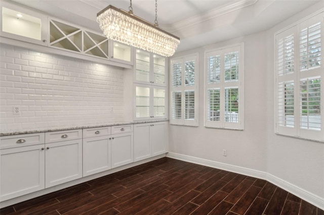 interior space with crown molding and a chandelier