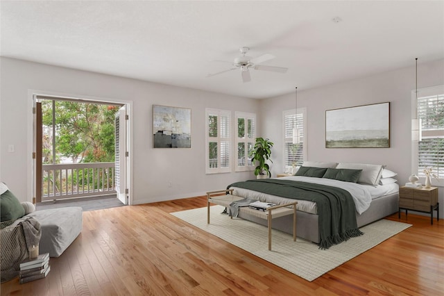 bedroom featuring multiple windows, access to outside, ceiling fan, and light hardwood / wood-style floors