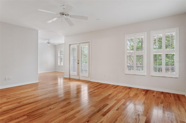 unfurnished room with french doors, light hardwood / wood-style floors, and ceiling fan