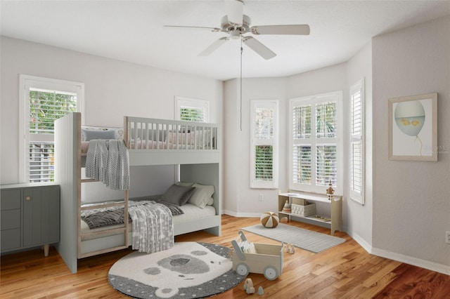 bedroom with ceiling fan and light hardwood / wood-style floors