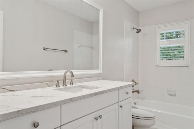 full bathroom featuring vanity, toilet, and tiled shower / bath