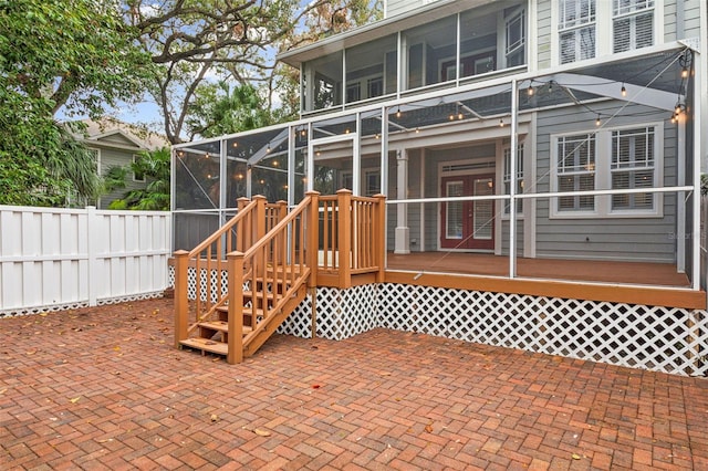 view of patio featuring a sunroom